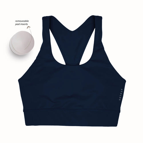 Person in a Athlos High intensity bra and Athlos Merino blue leggings performing an exercise.