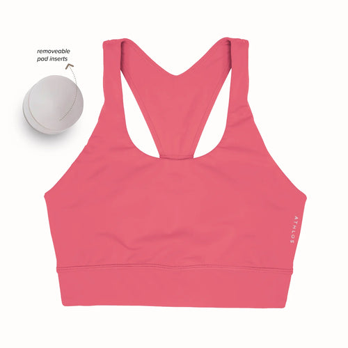 Person in a Athlos High intensity bra and Athlos Merino blue leggings performing an exercise.