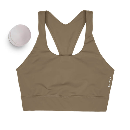 Person in a Athlos High intensity bra and Athlos Merino blue leggings performing an exercise.