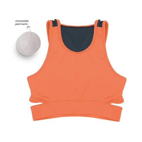 Women wearing a green Athlos Mid Intensity bra with a neutral background