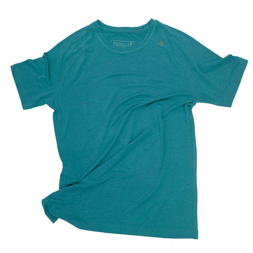 Man running outdoors in a green mens distance tee with sunglasses