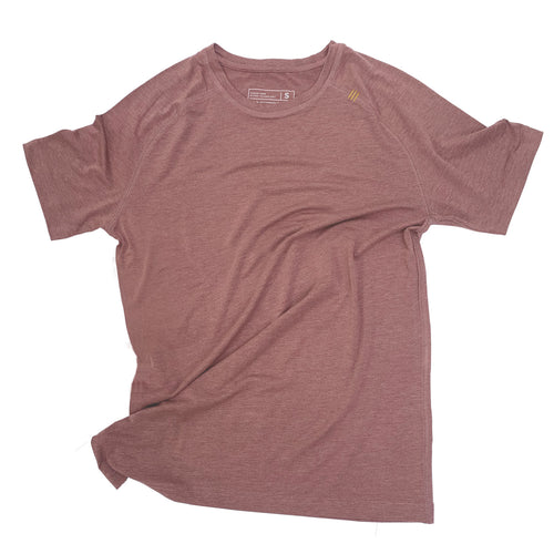 Man running outdoors in a green mens distance tee with sunglasses