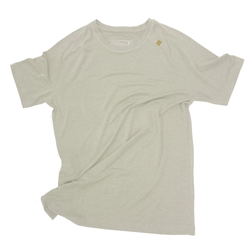 Man running outdoors in a green mens distance tee with sunglasses