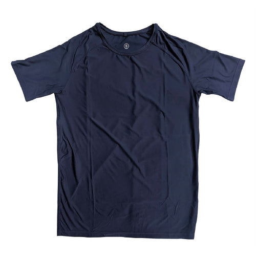 Man in a zero tee walking through tall grass.