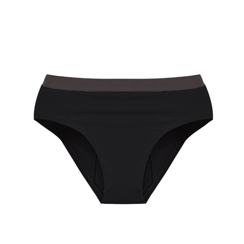 Person in a Athlos bra and Athlos Period underwear sitting on the floor with a bag.