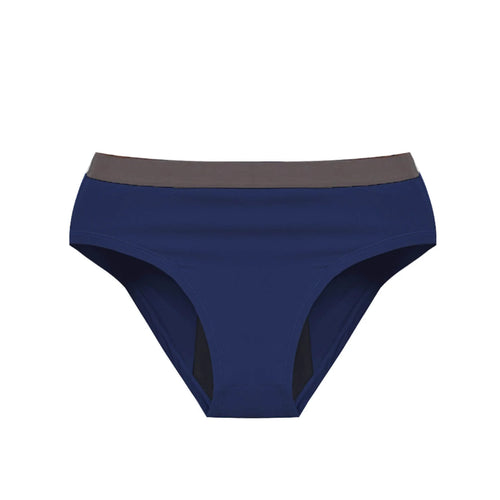 Person in a Athlos bra and Athlos Period underwear sitting on the floor with a bag.
