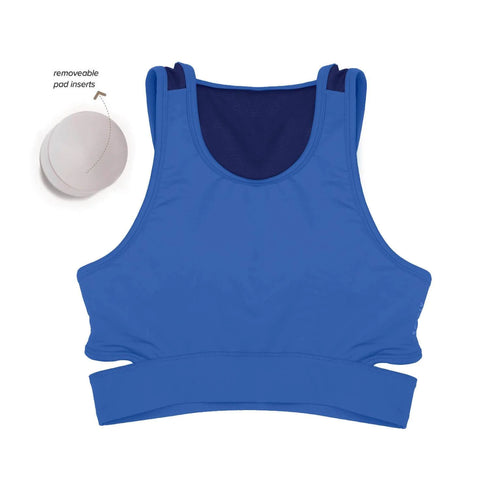 Women wearing a green Athlos Mid Intensity bra with a neutral background