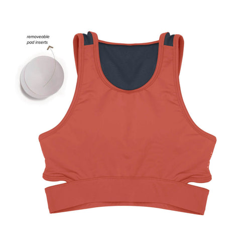 Women wearing a green Athlos Mid Intensity bra with a neutral background