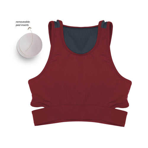 Women wearing a green Athlos Mid Intensity bra with a neutral background