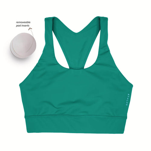 Person in a Athlos High intensity bra and Athlos Merino blue leggings performing an exercise.