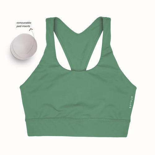 Person in a Athlos High intensity bra and Athlos Merino blue leggings performing an exercise.